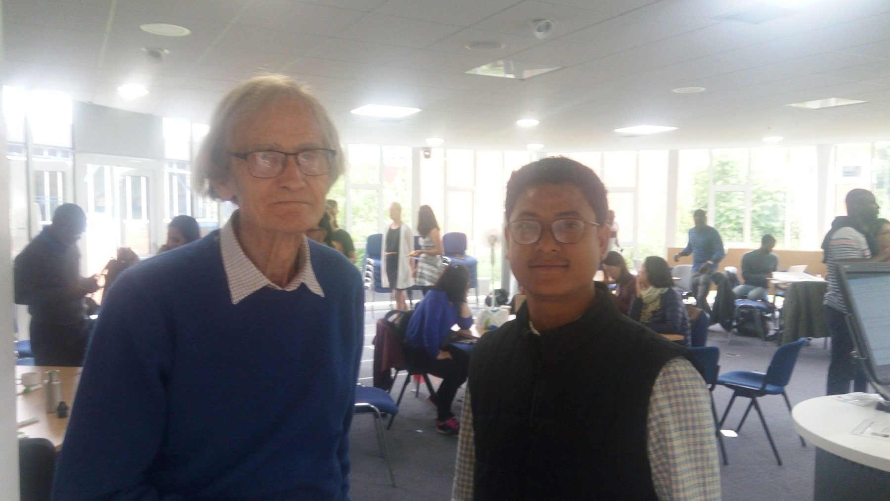 Dr. Rachan Daimary with a fellow researcher at an academic workshop in Brighton