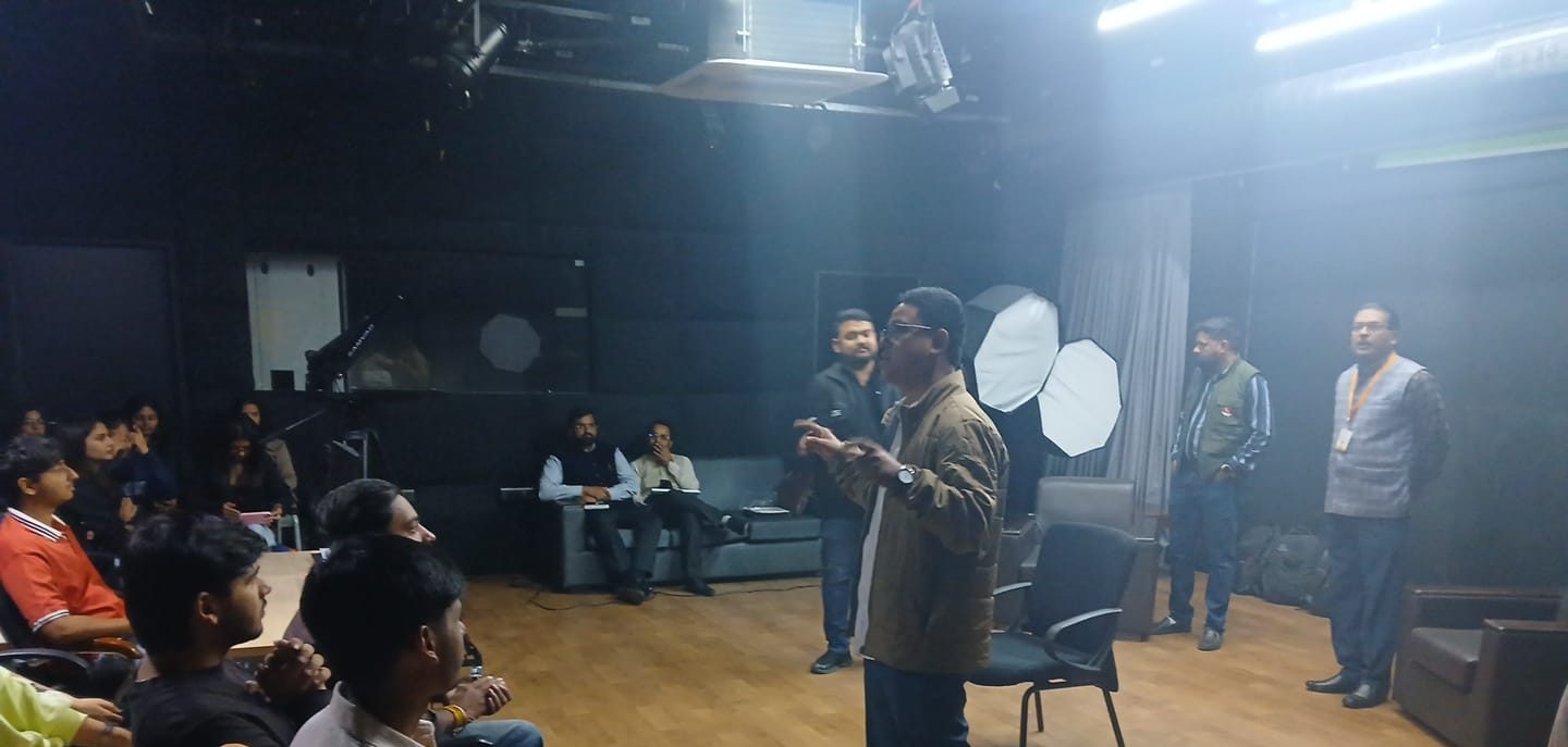 Dr. Rachan Daimary leading a studio session with students in a media production studio