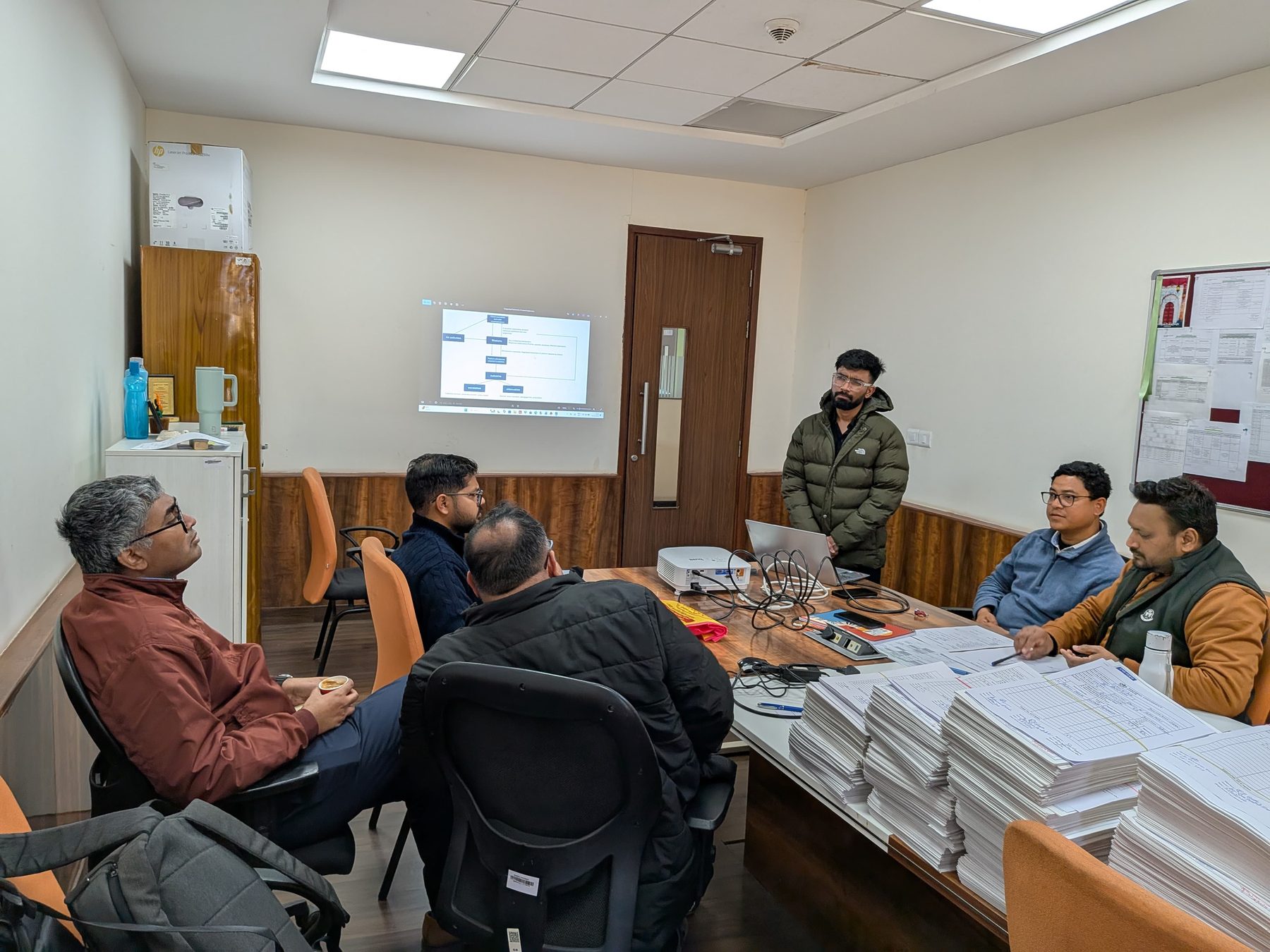 Researchers around a table during a project planning meeting