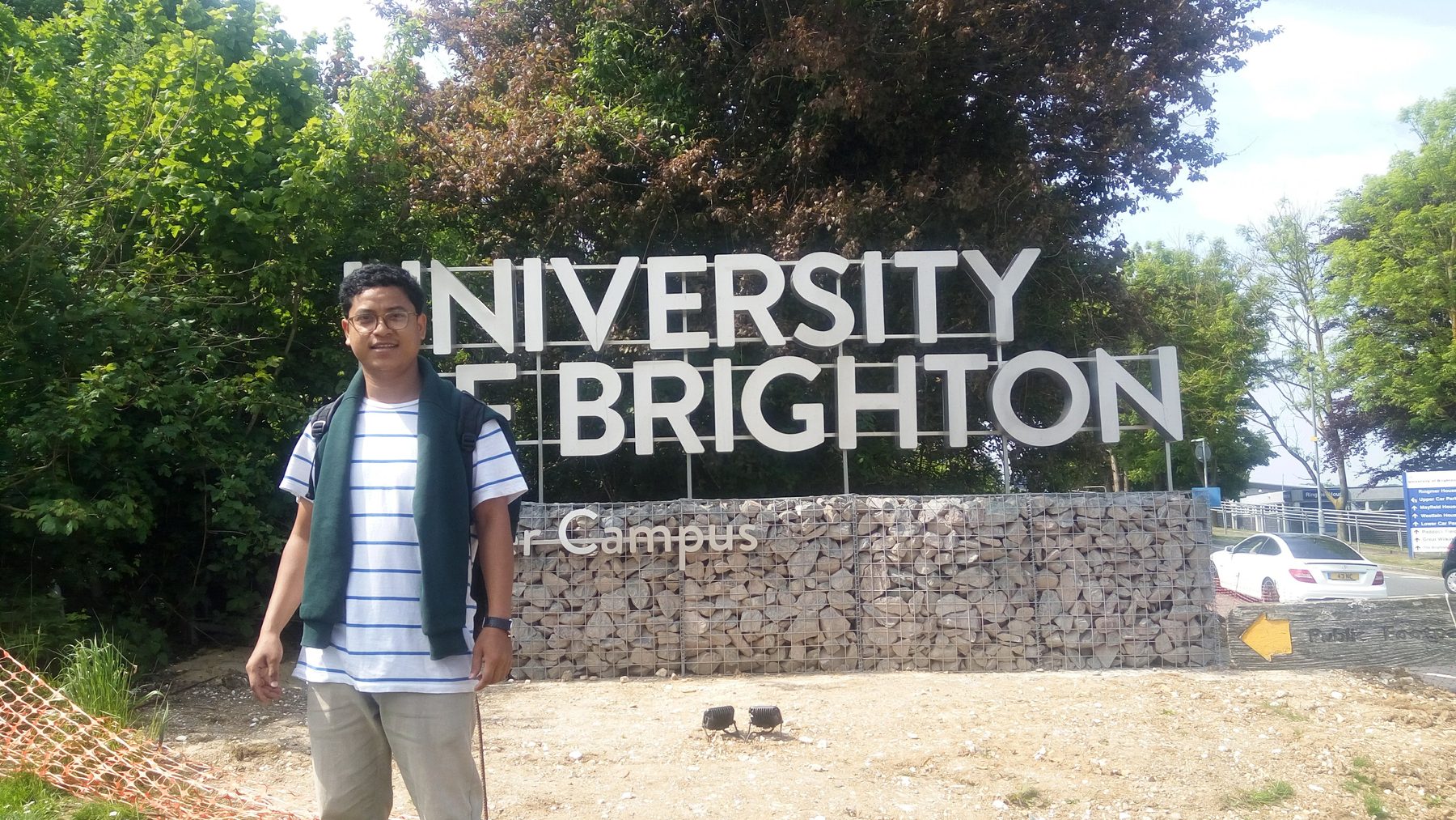 Dr. Rachan Daimary at the University of Brighton campus entrance